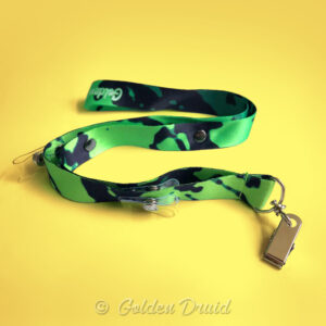 toxic green ultimate badge lanyard furry convention accessory in black and green splotches design pattern with multiple clips